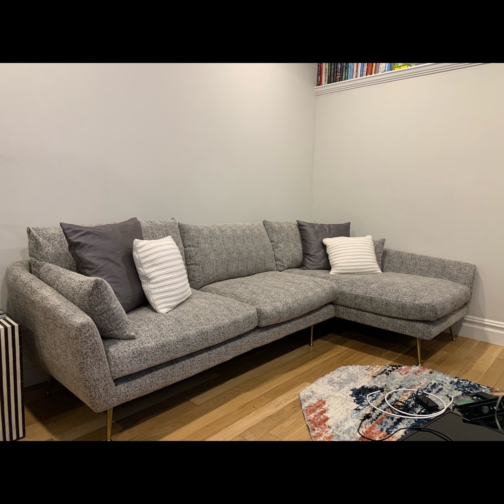 Modern couch with down feather cushions and marbled upholstery.